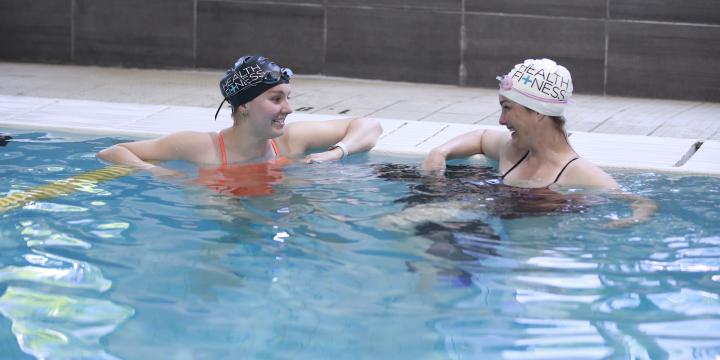 Instructor and student at the YWCA Health + Fitness Centre pool
