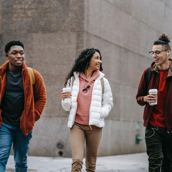 Young diverse people crossing the street